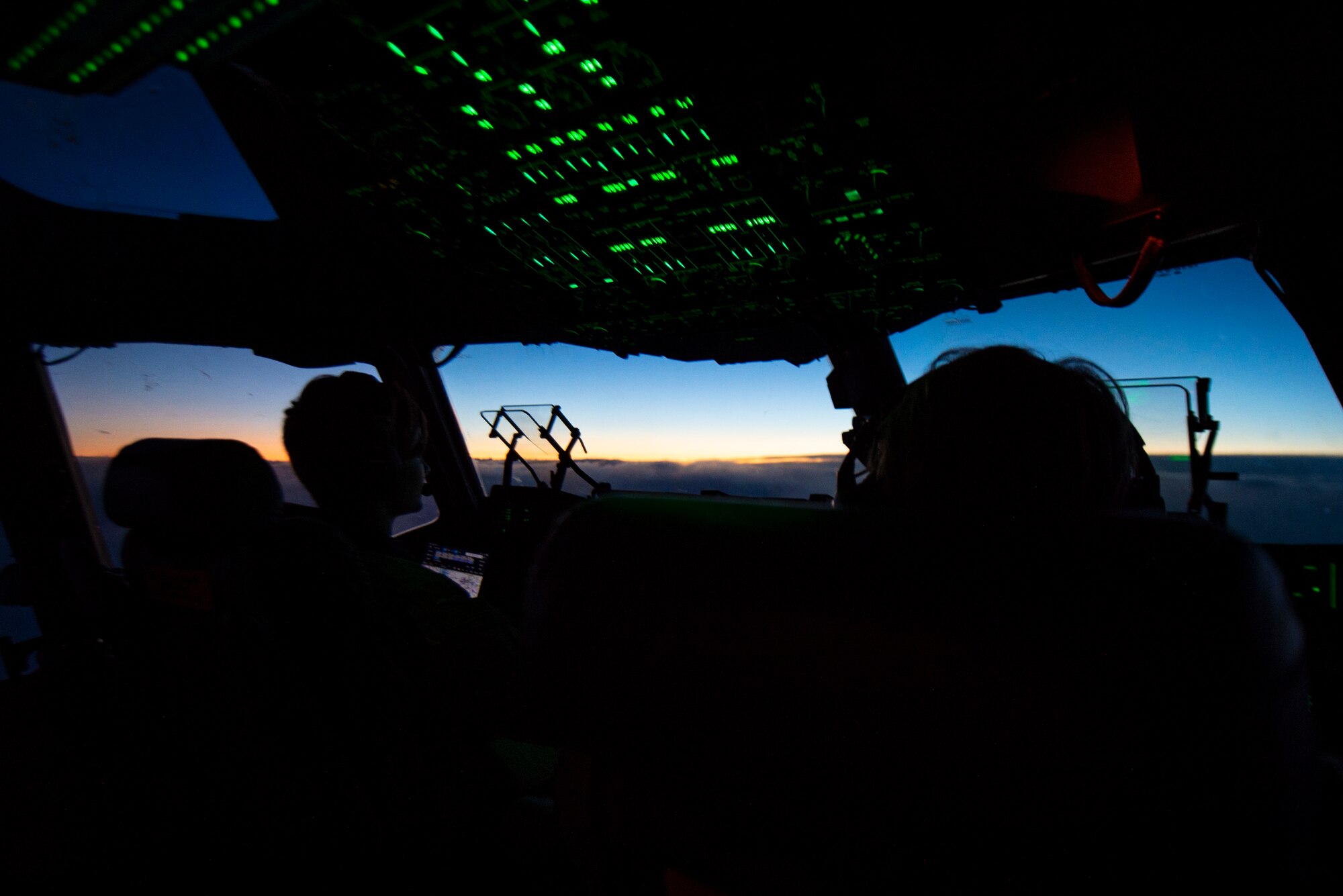 U.S. Air Force Capt. Emilia Kaiser, 8th Airlift Squadron pilot, left, flies a C-17 Globemaster III after taking off from Joint Base Lewis-McChord, Washington, during Exercise Rainier War 21B Nov. 6, 2021. The exercise is designed to demonstrate the wing’s ability to operate and survive while defeating challenges to the U.S. military advantage in all operating domains – air, land, sea and cyberspace. (U.S. Air Force photo by Staff Sgt. Tryphena Mayhugh)
