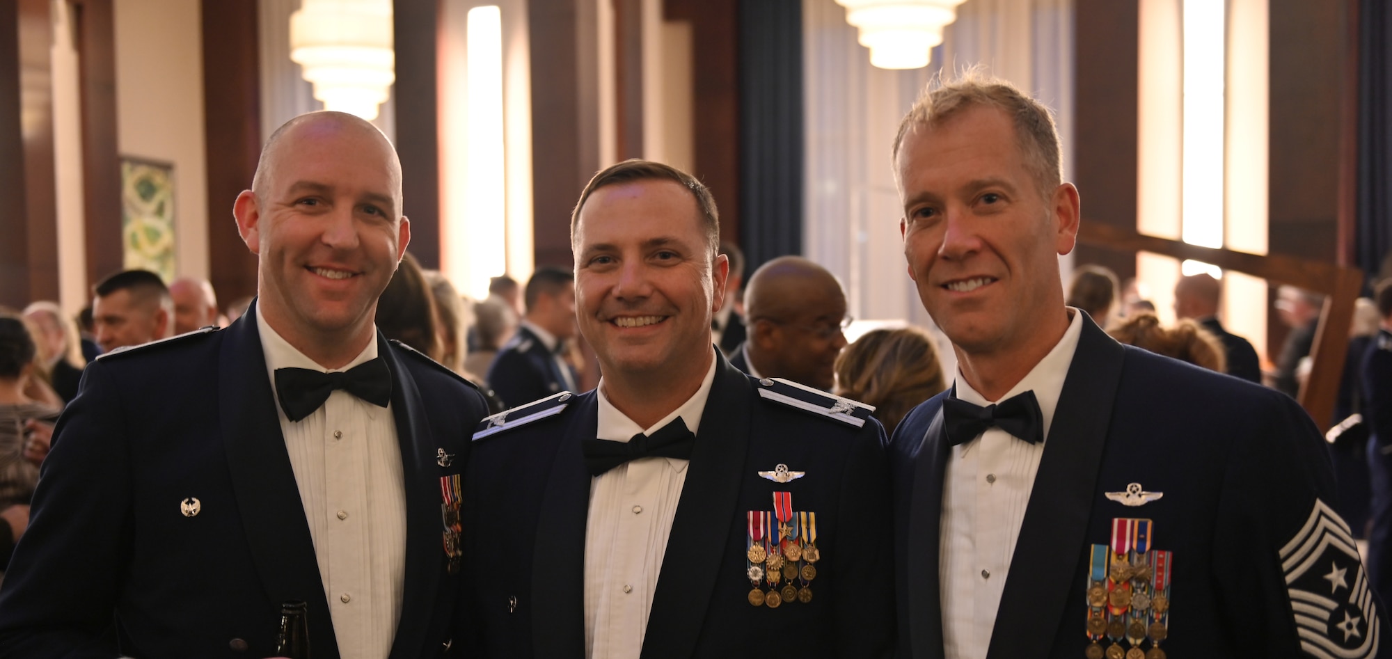 U.S. Air National Guard Col. Todd Wiles, commander of the 118th Wing, center, poses with Lt. Col. Christopher Francis, left and Chief Master Sgt. Trenton Williams, 118th Wing command chief, right, during the 105th Attack Squadron's 100th Anniversary Gala Oct 29, 2021, at the Hilton Hotel, Nashville, Tennessee. The 100th Anniversary Gala commemorated the 105th ATKS gaining of federal recognition in 1921. (U.S. Air National Guard photo by Staff Sgt. Jordan Harwood.)