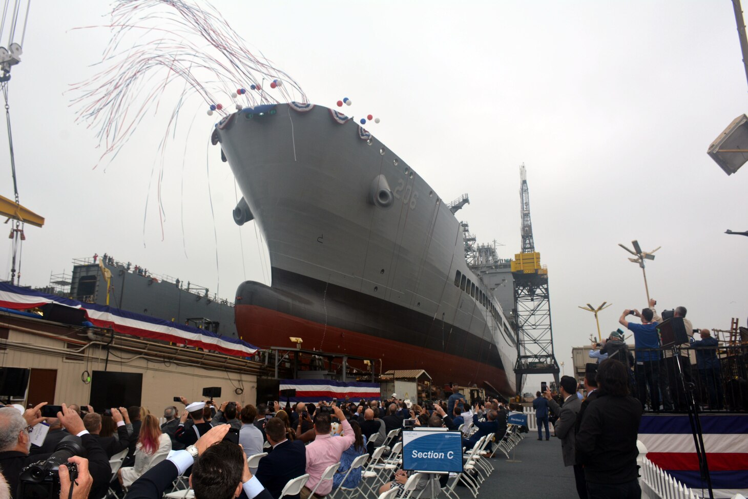 Military Sealift Command's newest ship, fleet replenishment oiler USNS Harvey Milk (T-AO 206), slides into the water during the christening ceremony at General Dynamic NASSCO, San Diego.