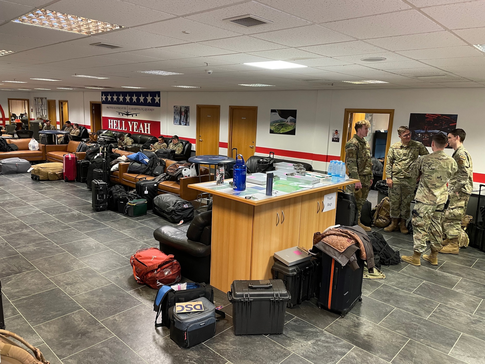 U.S. Airmen assigned to the 100th Air Refueling Wing wait with their luggage before their departure to air bases across Europe during exercise Castle Forge at Royal Air Force Mildenhall, England, Nov. 1, 2021. Exercising elements of Agile Combat Employment enables U.S. forces in Europe to operate from locations with varying levels of capacity and support, ensuring Airmen and aircrews are postured to deliver lethal combat power across the spectrum of military operations. Alongside F-15 operations in the Black Sea Region, Castle Forge encompasses the USAFE MAJCOM-wide Agile Combat Employment Initial Operating Capability capstone event. Both Castle Forge’s components will better enable forces to quickly disperse and continue to deliver air power from locations with varying levels of capacity and support, ensuring Airmen are always ready to respond to potential threats. (U.S. Air Force photo by Senior Airman Joseph Barron)