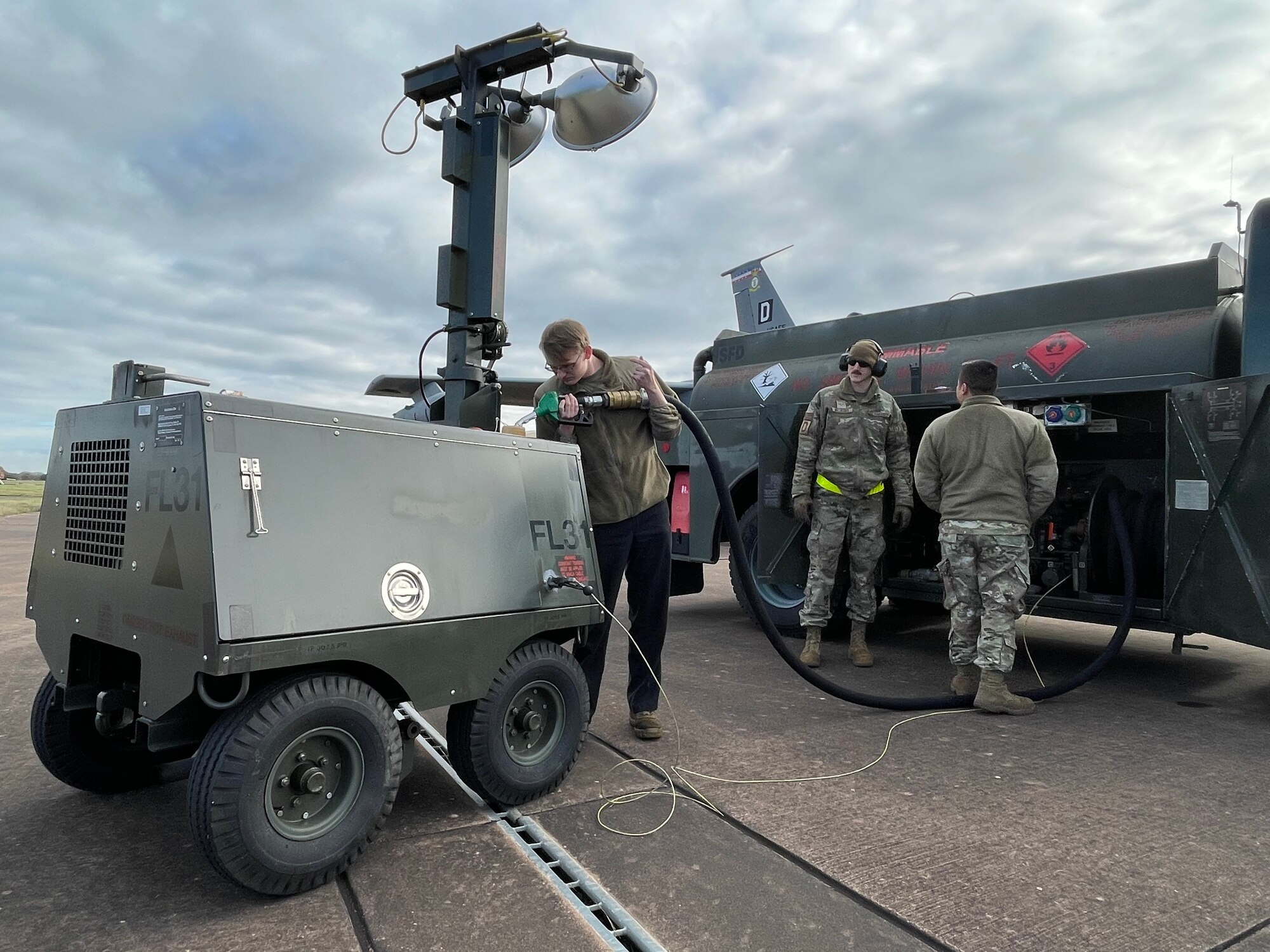 U.S. Airmen assigned to the 100th Air Refueling Wing fill an aerospace ground equipment light with diesel fuel during exercise Castle Forge at Royal Air Force Fairford, England, Nov. 3, 2021. The ability to quickly respond and reassure allies and partners rests upon the U.S. Air Force’s forward and ready presence in Europe. In addition to F-15 Eagle aircraft operations in the Black Sea Region, Castle Forge encompasses the USAFE-wide Agile Combat Employment capstone event. Castle Forge’s components will better enable forces to quickly disperse and continue to deliver air power from locations with varying levels of capacity and support, ensuring Airmen are always ready to respond to potential threats.  (U.S. Air Force photo by Senior Airman Joseph Barron)