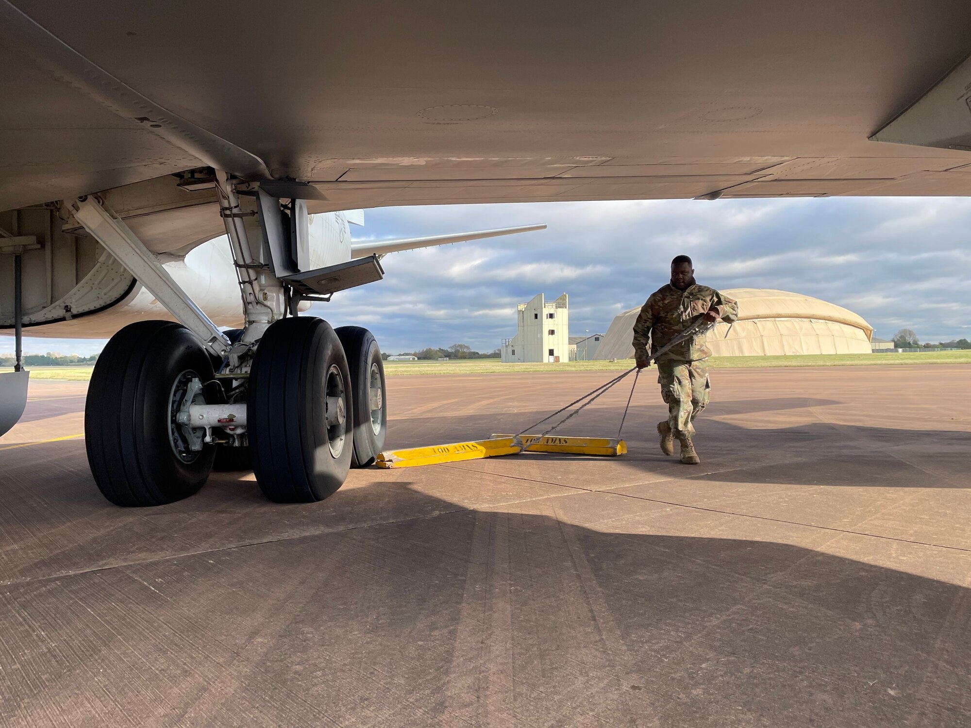 U.S. Air Force Senior Airman Santonio Portis, 100th Aircraft Maintenance Squadron electrical and environmental journeyman, removes aircraft wheel chocks from a KC-135 Stratotanker aircraft prior to flight during exercise Castle Forge at Royal Air Force Fairford, England, Nov. 3, 2021. Exercising elements of Agile Combat Employment enables U.S. forces in Europe to operate from locations with varying levels of capacity and support, ensuring Airmen and aircrews are postured to deliver lethal combat power across the spectrum of military operations. In addition to F-15 Eagle aircraft operations in the Black Sea Region, Castle Forge encompasses the USAFE-wide ACE capstone event. Castle Forge’s components will better enable forces to quickly disperse and continue to deliver air power from locations with varying levels of capacity and support, ensuring Airmen are always ready to respond to potential threats. (U.S. Air Force photo by Senior Airman Joseph Barron)