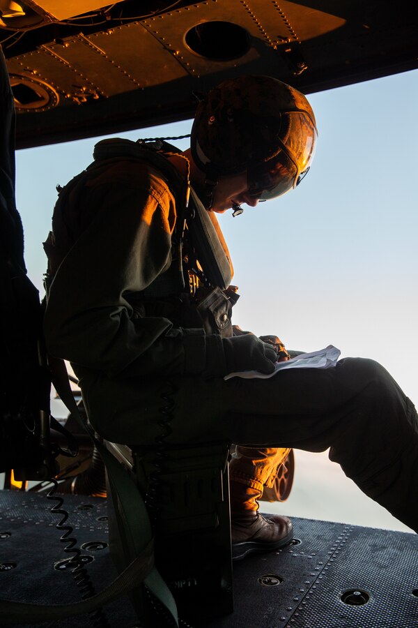 U.S. Marine Cpl. Robert Sponable, a UH-1Y Venom helicopter crew chief with Marine Light Attack Helicopter Squadron 775, Marine Aircraft Group 41, 4th Marine Aircraft Wing, marks the location of targets on Marine Corps Base Camp Pendleton, California, Nov. 4, 2021. The reservists of HMLA-775 provide aviation support that enables I Marine Expeditionary Force and Marine Corps Base Camp Pendleton tenant commands the ability to maintain and enhance their combat readiness. (U.S. Marine Corps photo by Lance Cpl. Hope Straley)