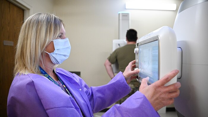 Rhonda Janroy uses a digital screen to take a patient's x-ray.
