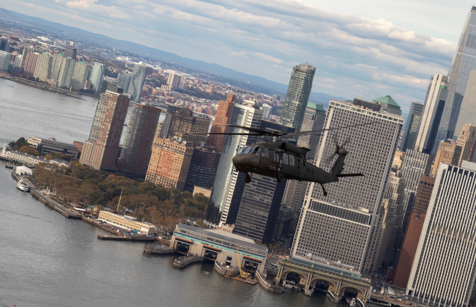 A New York Army National Guard UH-60 helicopter flies past lower Manhattan while carrying officers and noncommissioned officers taking part in the New York Army National Guard's Dense Urban Leaders Operations Course, to give participants a feel for the city's layout. The five-day course is geared to train and educate staff officers and senior noncommissioned officers in the planning and execution of operations in complex urban environments.