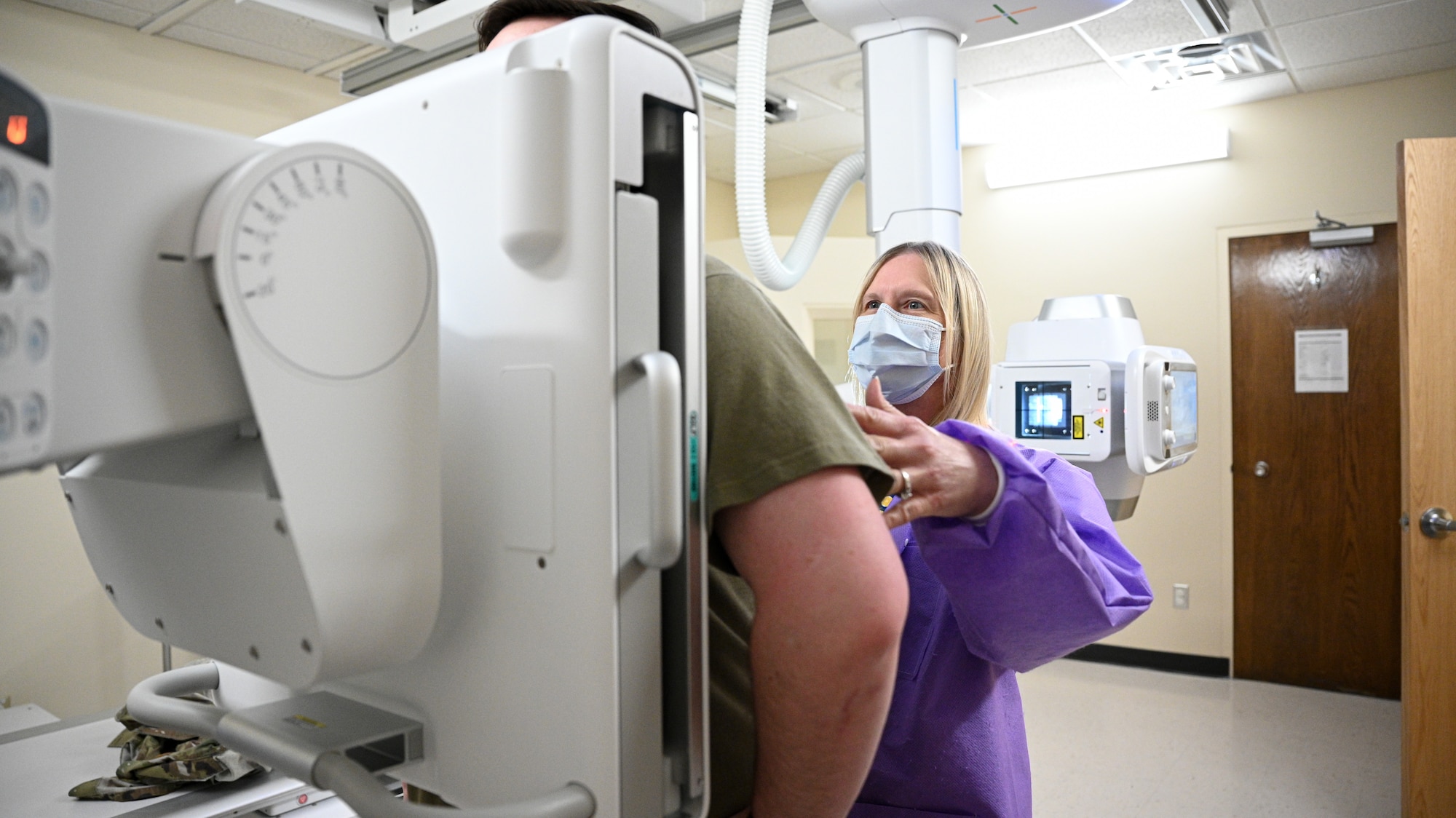Rhonda Janroy positions a patient for an x-ray