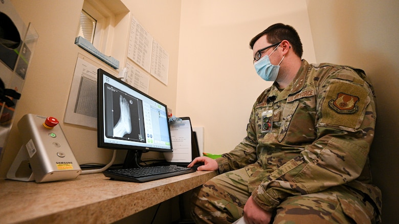 Staff Sgt. Anthony Hiser looks at an x-ray on an computer screen.