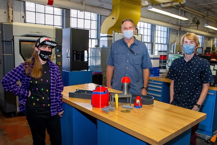 Additive Manufacturing 3-D Printer Operator Dixie Cox,  REAL Ideas Program Manager Scott Burford, and Research, Development, Testing, and Evaluation (RDT&E) Manager Joey Hoellerich stand ready to assist in the Norfolk Naval Shipyard Technology and Innovation (T&I) Lab.