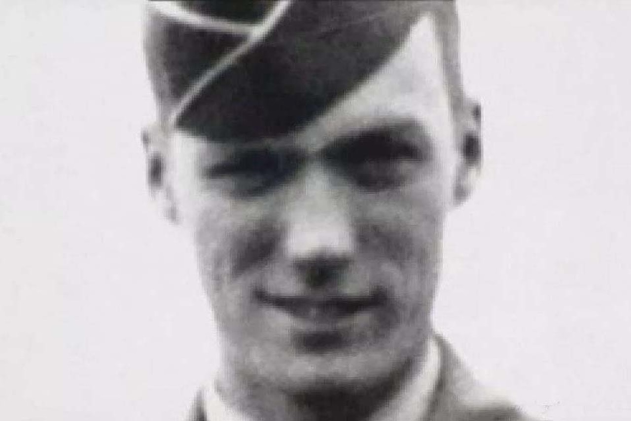 A soldier poses for a photo.