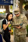 Soldier and civilian reading papers.