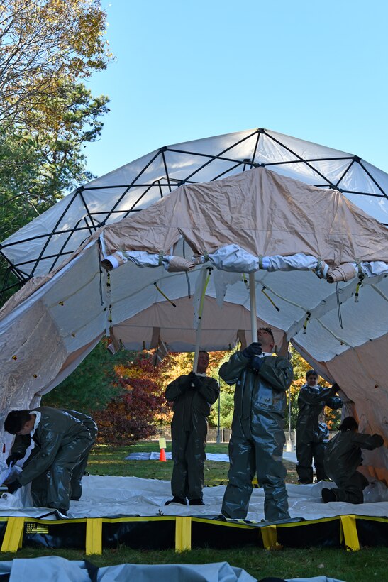 Airmen with the 104th Medical Group set up a decontamination tent during a midpoint inspection readiness exercise November 6, 2021 at Barnes Air National Guard Base, Massachusetts. Midpoint inspections are conducted to evaluate the wing’s capabilities to respond to threats in a contested, degraded, and operationally limited environment. (U.S. Air National Guard photo by Staff Sgt. Hanna Smith)
