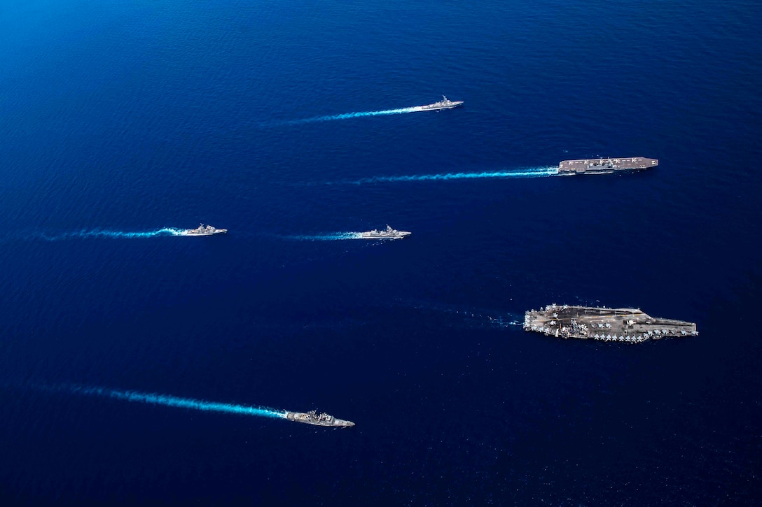 Six ships sail in formation.