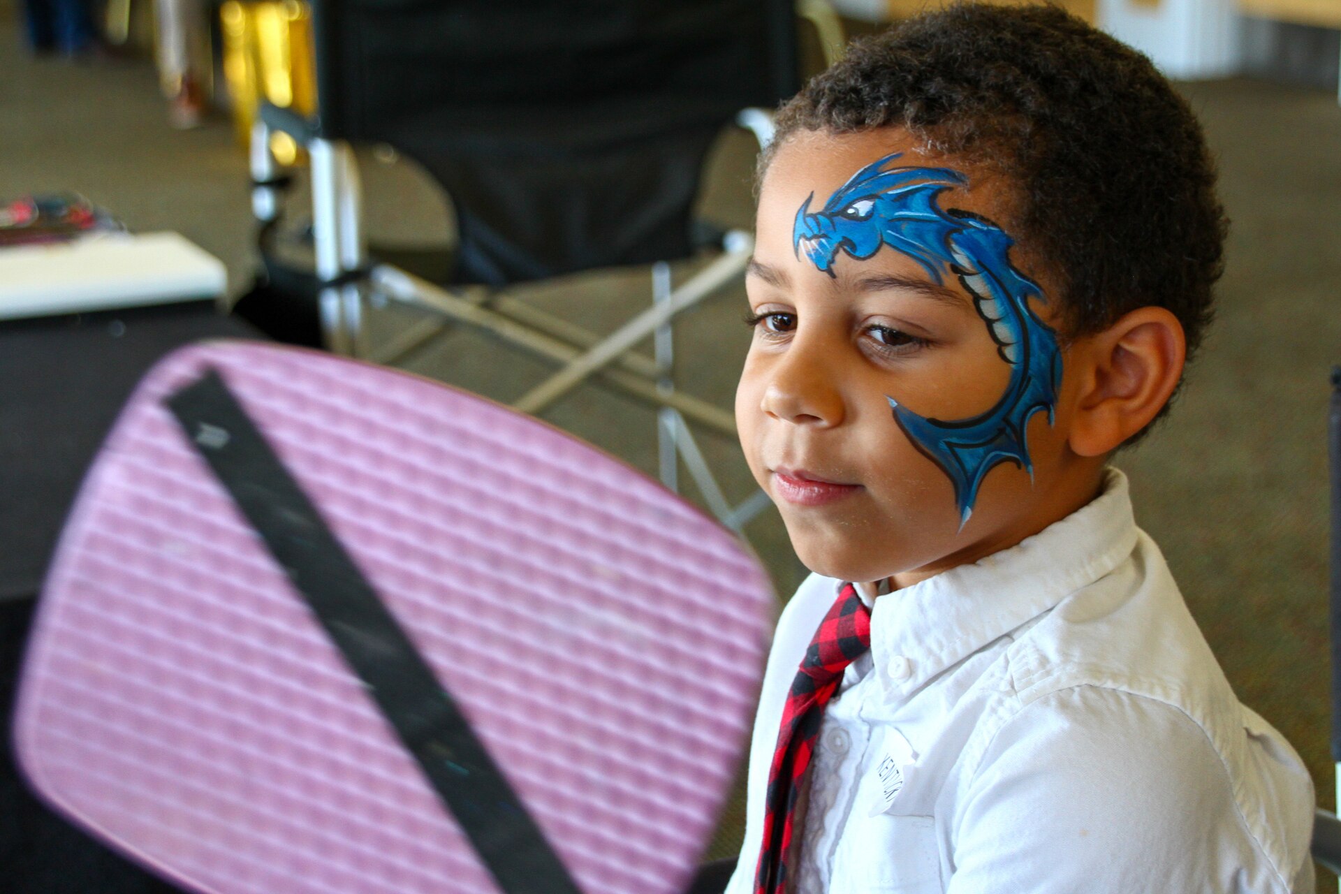 Darrin Kristopher Payne, the nephew of fallen soldier Sgt. Darrin K. Potter of the 223rd Military Police Company, admires his face painting at the Survivor Outreach Services Day at the Races at Churchill Downs in Louisville, Ky. Nov. 7, 2021. Survivor Outreach Services Day at the Races is an annual event held to honor the lives of fallen services members. (U.S. Army National Guard photo by Sgt. Matt Damon)