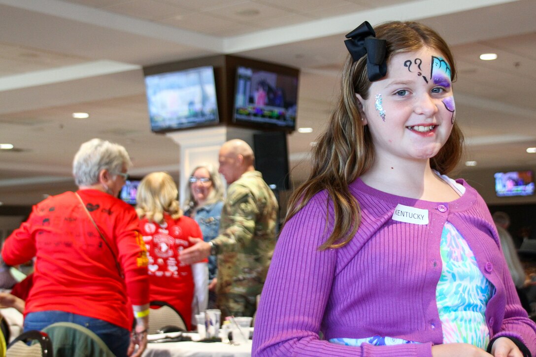 Hadley Gruner, the niece of fallen soldier Cpl. Matthew J. Stanley of the 1st Cavalry, poses for a photograph displaying her face painting at the Survivor Outreach Services Day at the Races at Churchill Downs in Louisville, Ky. Nov. 7, 2021. Survivor Outreach Services Day at the Races is an annual event held to honor the lives of fallen services members. (U.S. Army National Guard photo by Sgt. Matt Damon)
