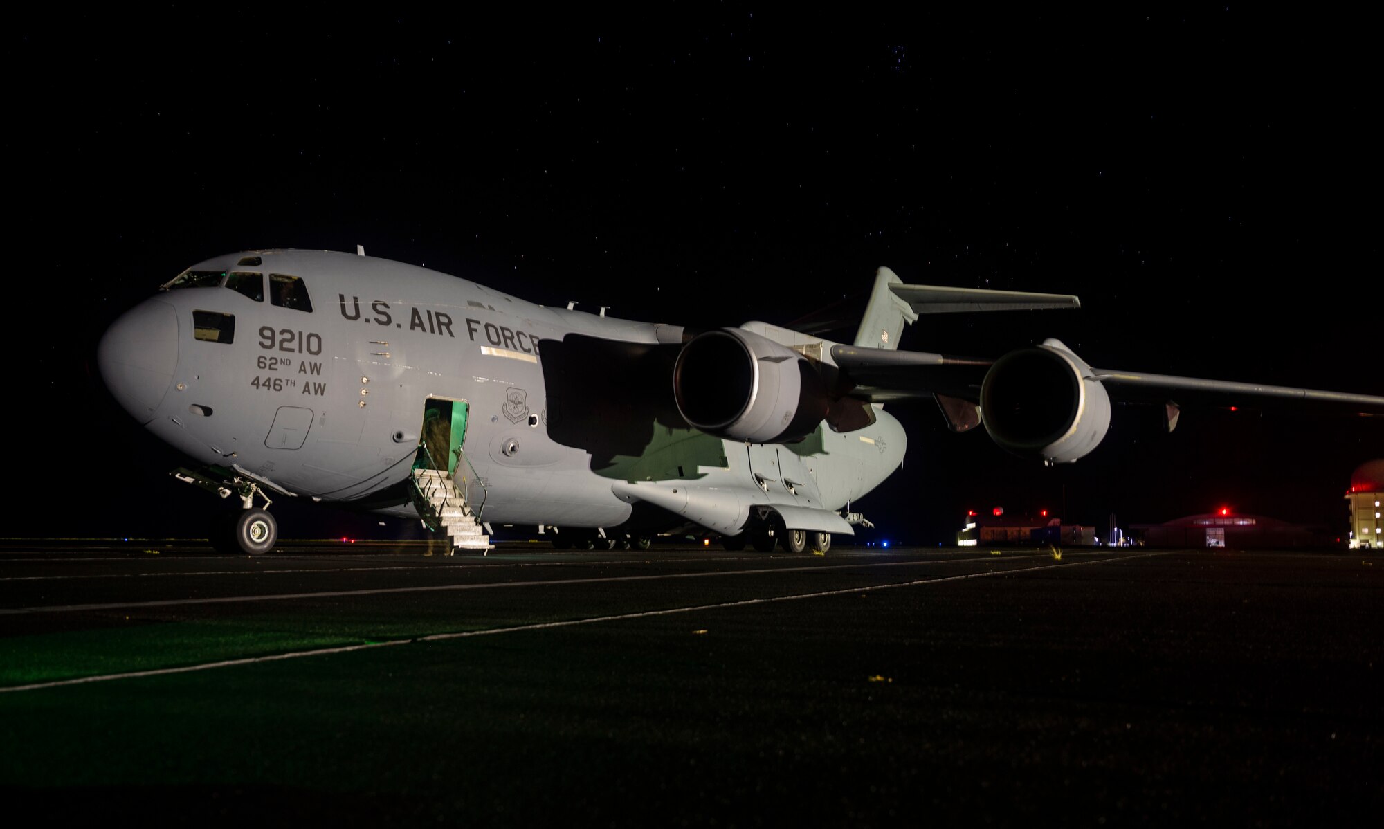 A C-17 Globemaster III, assigned to Joint Base Lewis-McChord, Washington, sits on the flightline in Iwo Jima, Japan, during Exercise Rainier War 21B, Nov. 7, 2021. Rainier War 21B exercises and evaluates the 62nd Airlift Wing’s ability to employ the force and their ability to perform during wartime and contingency taskings in a high-intensity, wartime contested, degraded and operationally limited environment while supporting the contingency operations against a near-peer adversary in the U.S. Indo-Pacific Command area of responsibility. (U.S. Air Force photo by Staff Sgt. Rachel Williams)