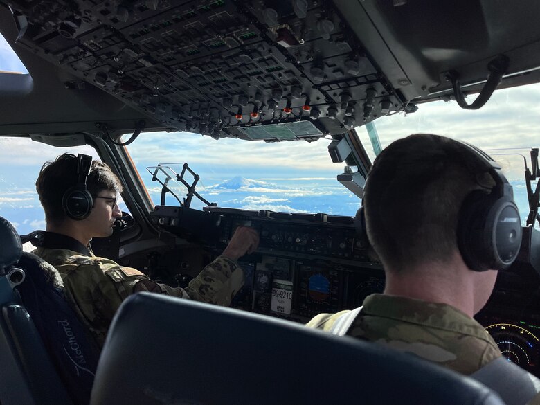 U.S. Air Force 1st Lt. Christopher Ferrario, left, a co-pilot with the 7th Airlift Squadron, and U.S. Air Force Maj. John Greenway, a pilot with the 7th AS, fly a C-17 Globemaster III by Mount Fuji, Japan, during Exercise Rainier War 21B, Nov. 7, 2021. Rainier War 21B exercises and evaluates the 62nd Airlift Wing’s ability to employ the force and their ability to perform during wartime and contingency taskings in a high-intensity, wartime contested, degraded and operationally limited environment while supporting the contingency operations against a near-peer adversary in the U.S. Indo-Pacific Command area of responsibility. (U.S. Air Force photo by Staff Sgt. Rachel Williams)