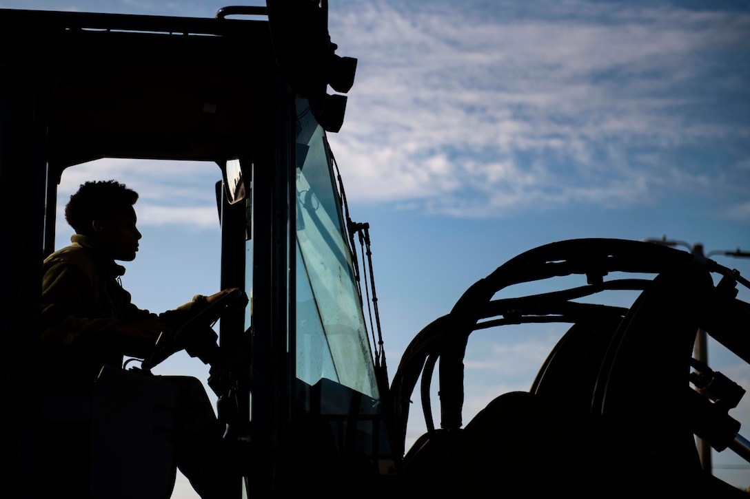 An airman operates a forklift.