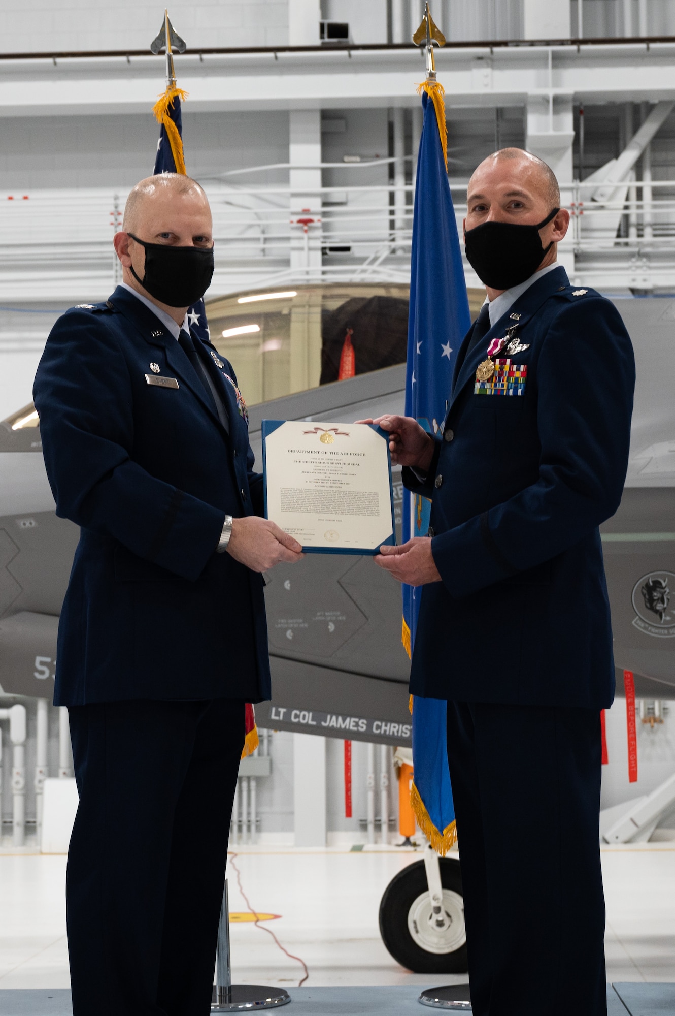 U.S. Air Force Col. Lawrence Evert, the 354th Operations Group commander (left), and Lt. Col. Jim Christensen, former 356th Fighter Squadron (FS) commander, pose for a photo during a change of command ceremony on Eielson Air Force Base, Alaska, Nov. 5, 2021.