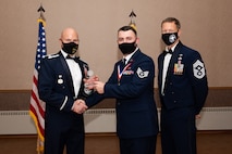 U.S. Air Force Staff Sgt. Beaux Hebert, a 354th Fighter Wing Public Affairs mass communication journeyman, receives the Distinguished Graduate Award during the Airman Leadership School (ALS) Class 22-1 graduation ceremony on Eielson Air Force Base, Alaska, Nov. 5, 2021.
