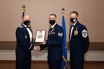 U.S. Air Force Staff. Sgt. Ryan Cole, a 354th Operational Medical Readiness Squadron bioenvironmental engineering technician, receives the John L. Levitow Award during the Airman Leadership School (ALS) Class 22-1 graduation ceremony on Eielson Air Force Base, Alaska, Nov. 5, 2021.