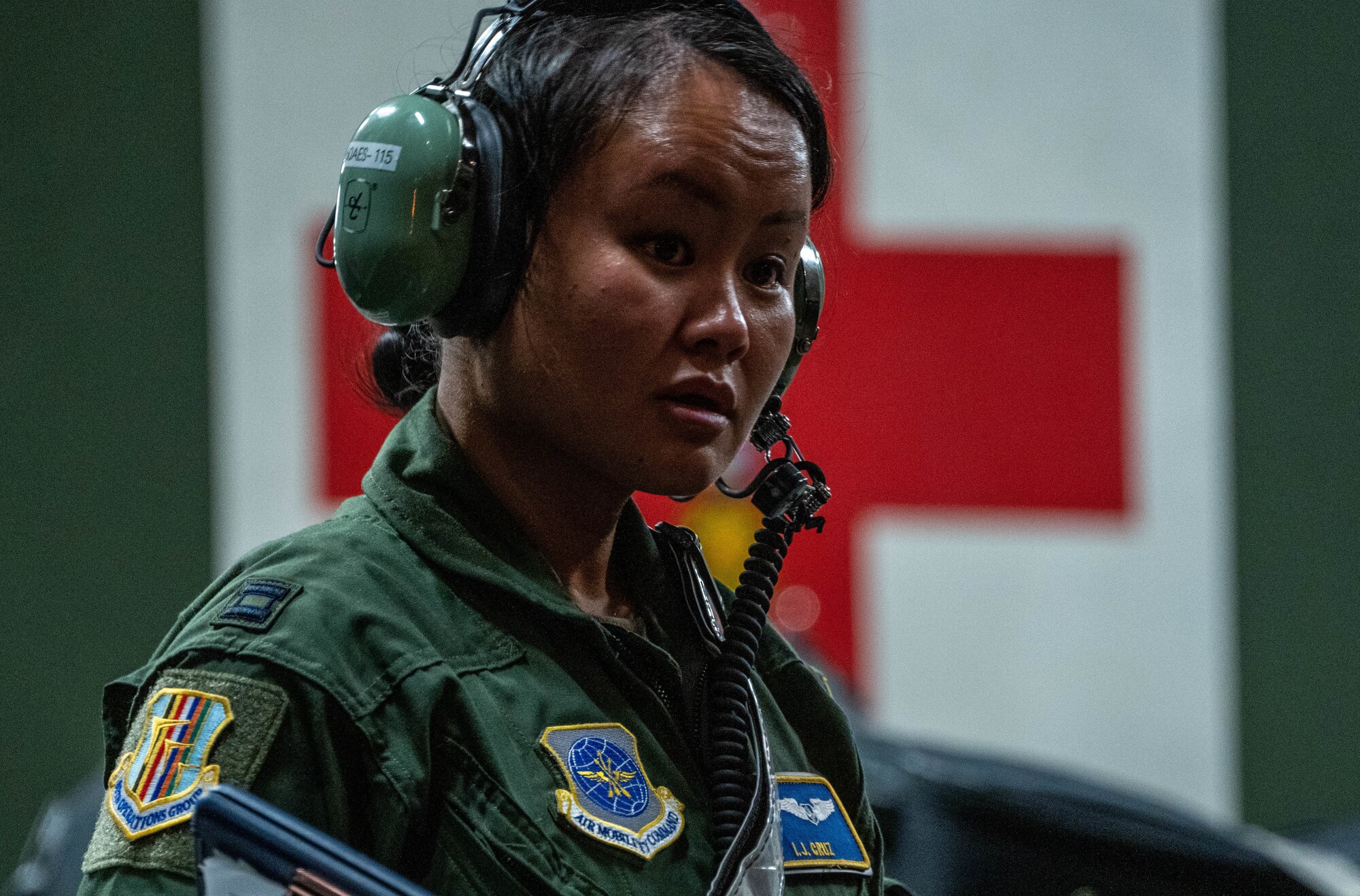 Capt Iris Joy Cruz, 60th Operations Group aeromedical crew member, directs Airmen and patients off of a C-17 Globemaster III during an aeromedical evacuation mission at Joint Base Pearl Harbor-Hickam, Hawaii, Nov. 4, 2021. Aeromedical evacuation crews execute patient care and patient movement on U.S. Air Force aircraft and can operate in austere locations. (U.S. Air Force photo by Airman 1st Class Makensie Cooper)