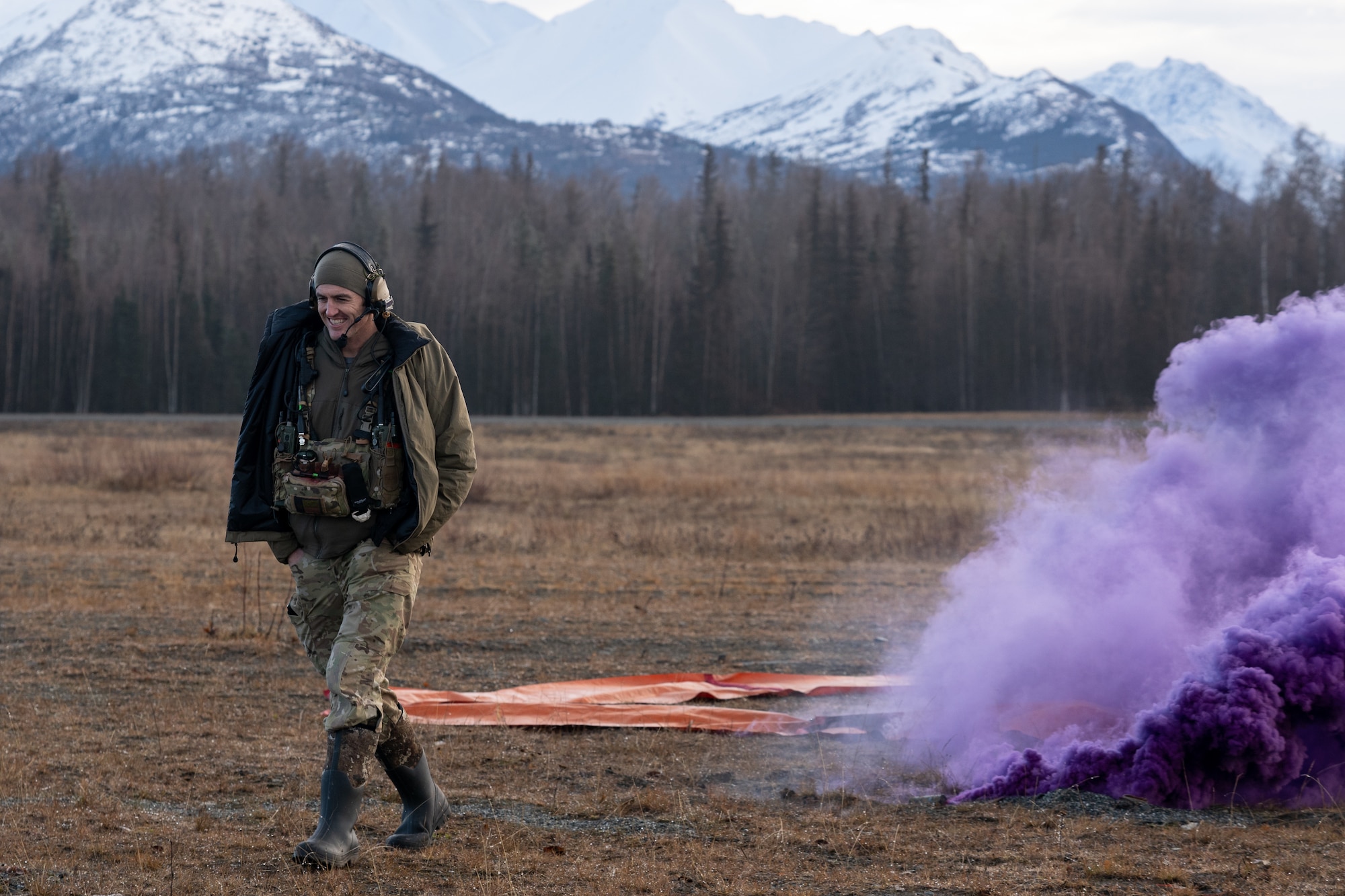 U.S. Air Force Staff Sgt. Tanner Boyer, a combat controller assigned to the 212th Rescue Squadron, Alaska Air National Guard, returns from the drop zone after throwing a smoke grenade during a training event at Joint Base Elmendorf-Richardson.