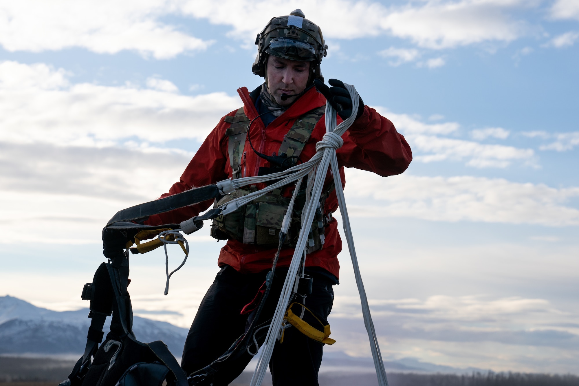 U.S. Air Force Master Sgt. Dan Lutz, a pararescueman assigned to the 212th Rescue Squadron, Alaska Air National Guard, recovers a parachute after a successful jump during a training event Joint Base Elmendorf-Richardson.