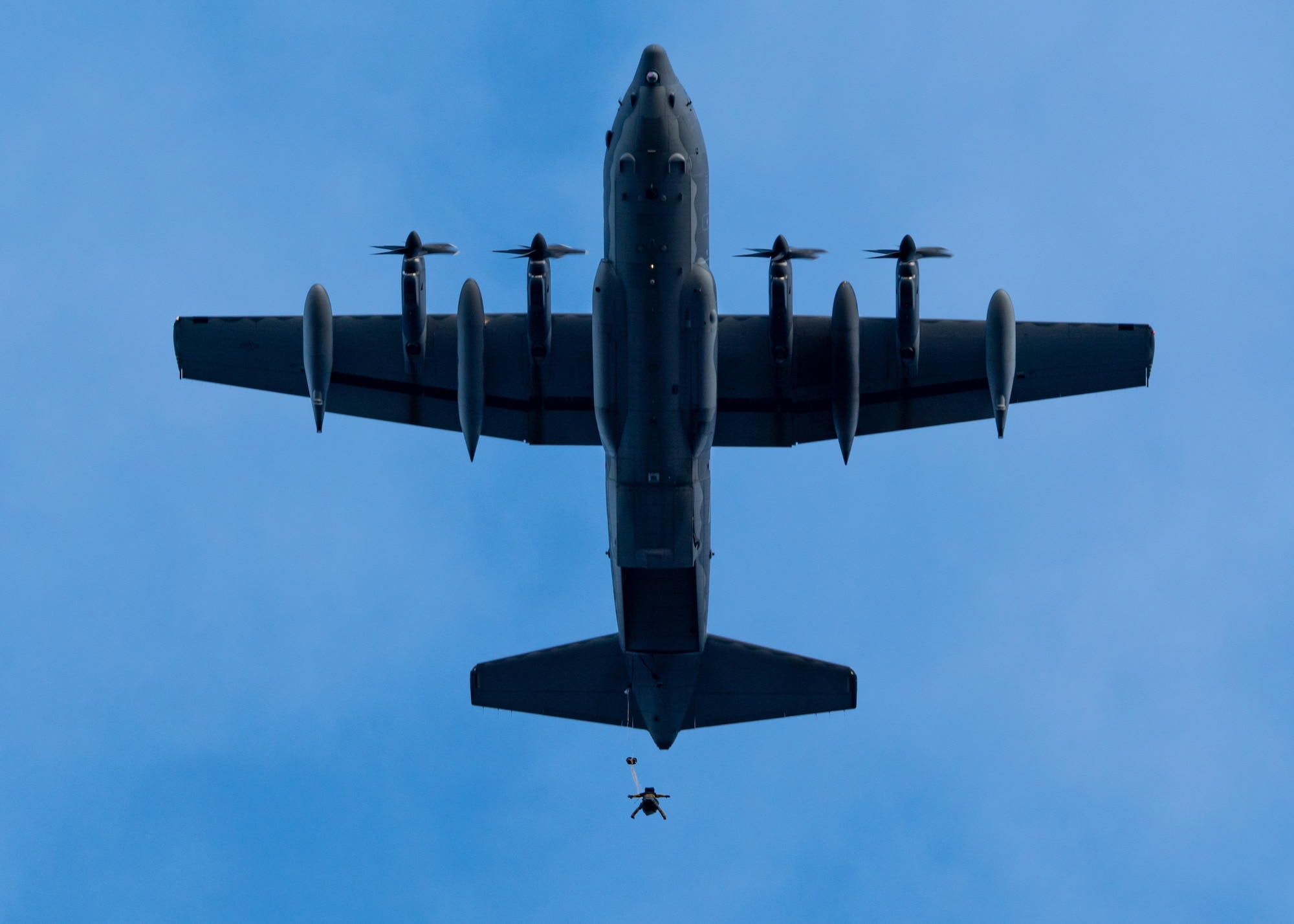 A pararescueman assigned to the 212th Rescue Squadron leaps from an Alaska Air National Guard HC-130J Combat King II operated by an aircrew from the 211th Rescue Squadron during a training event at Joint Base Elmendorf-Richardson, Alaska.