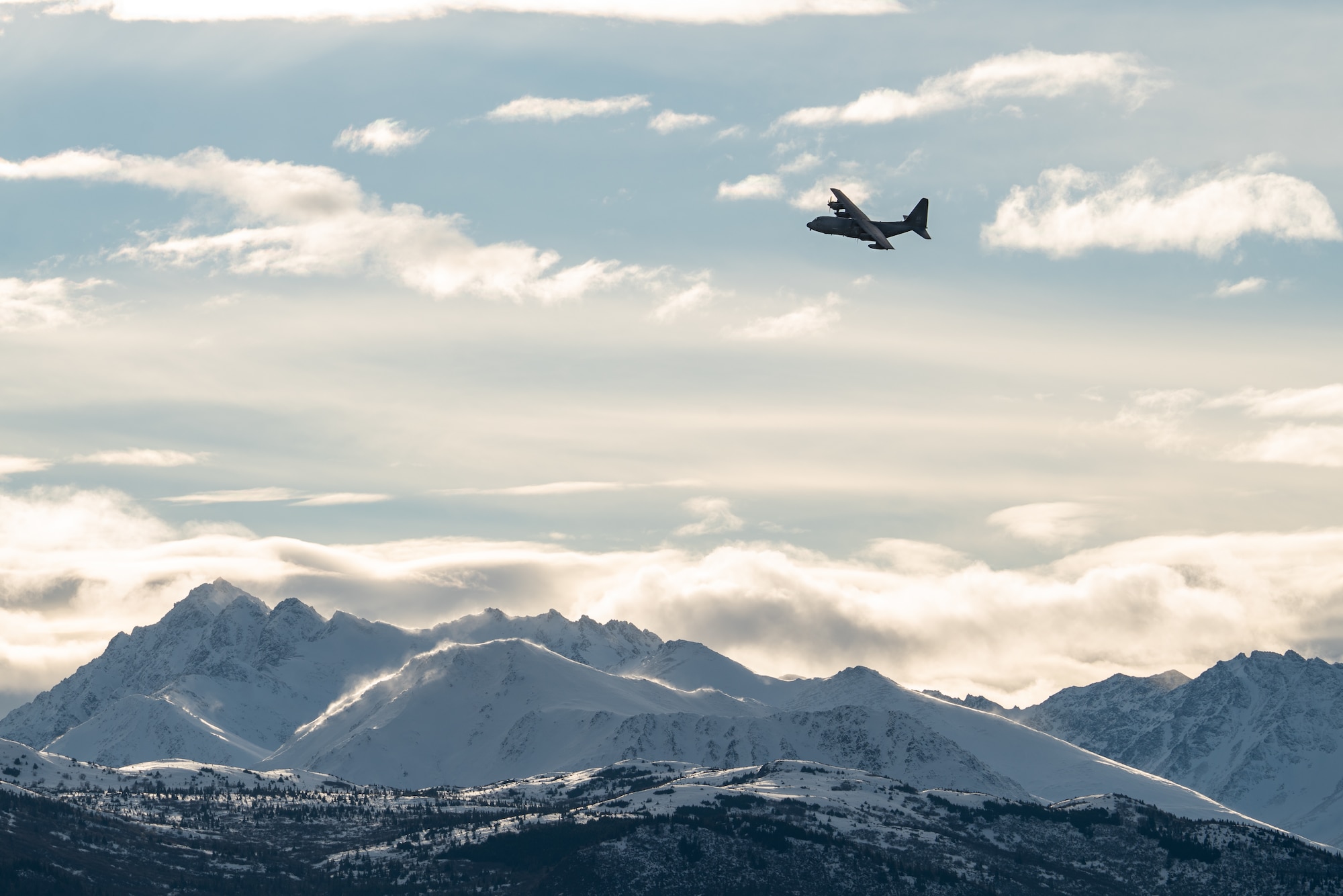 An Alaska Air National Guard HC-130J Combat King II operated by an aircrew from the 211th Rescue Squadron flies above Malemute Drop Zone during a training exercise at Joint Base Elmendorf-Richardson.
