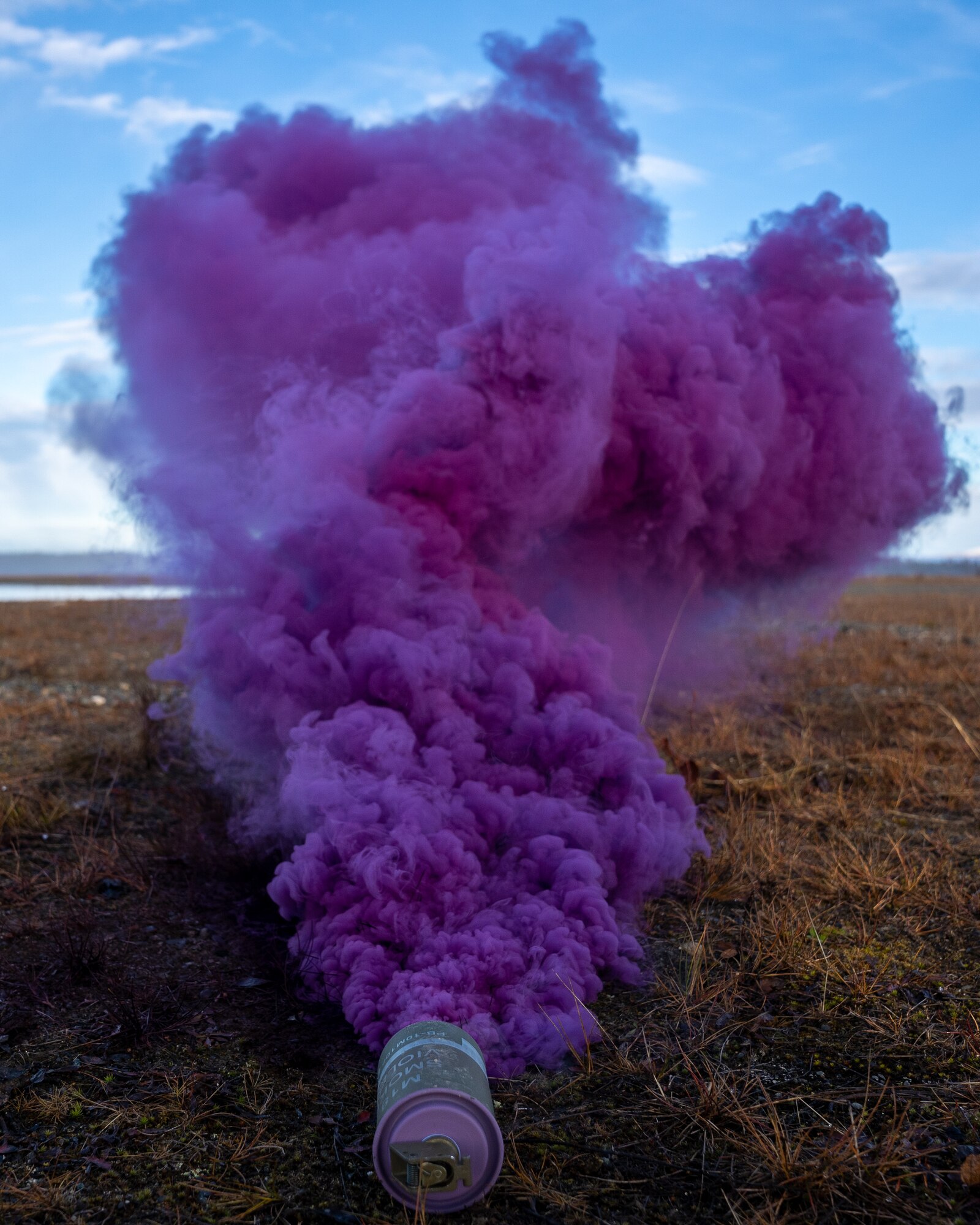 An M18 smoke grenade is used as a landing spot for pararescuemen during a training event at Joint Base Elmendorf-Richardson.