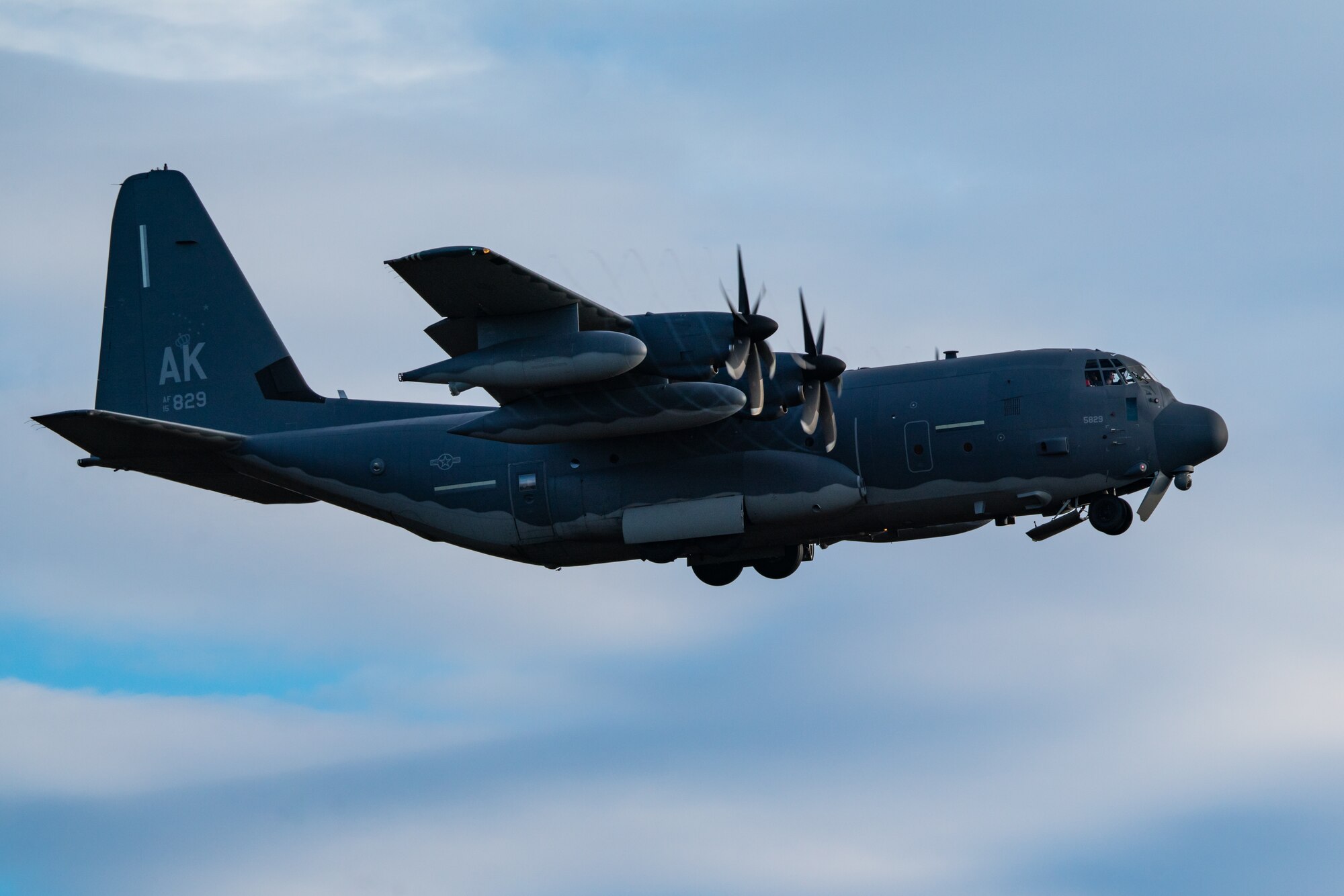 An Alaska Air National Guard HC-130J Combat King II operated by an aircrew from the 211th Rescue Squadron flies above Malemute Drop Zone during a training exercise at Joint Base Elmendorf-Richardson.