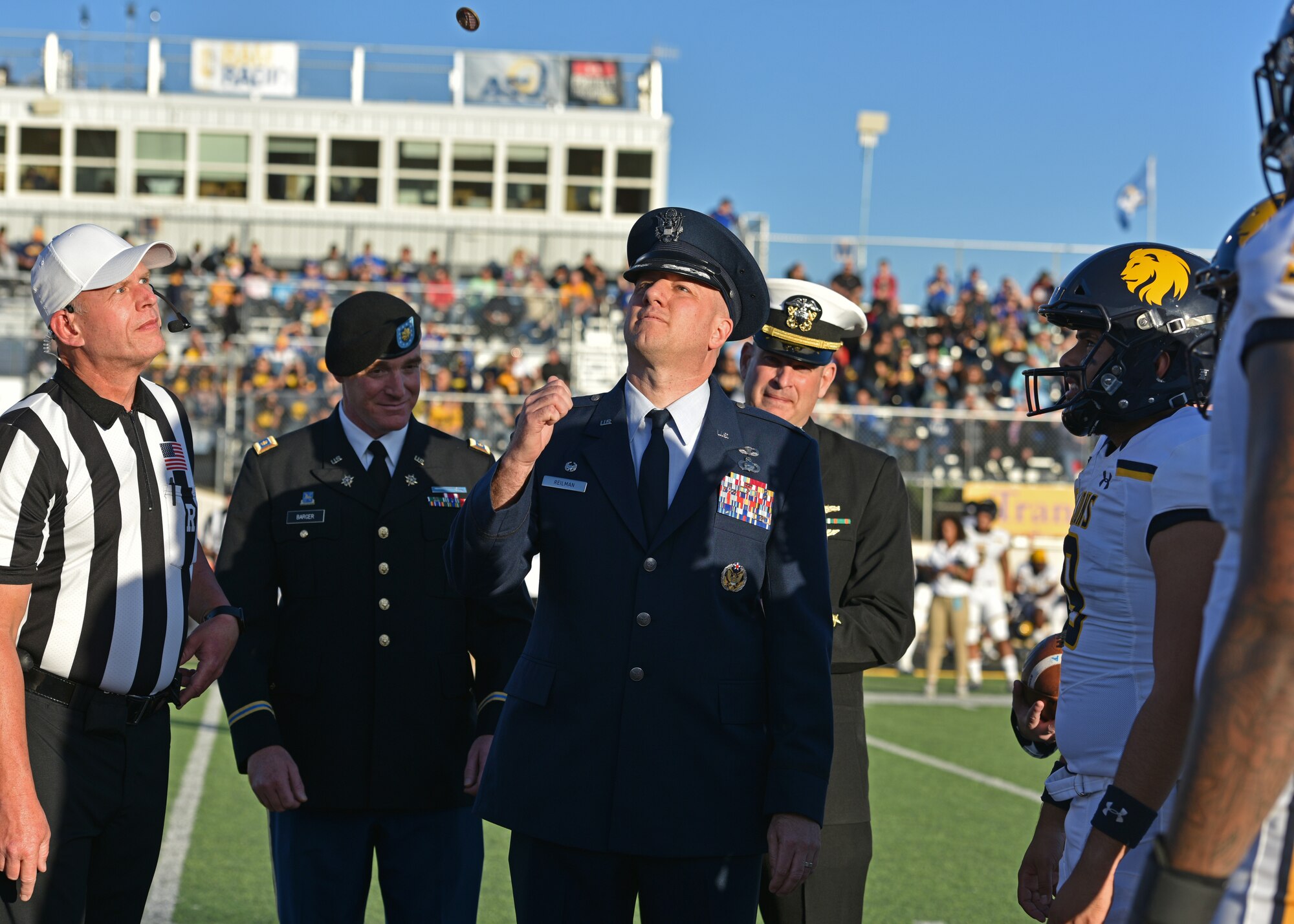 U.S. Air Force Col. Matthew Reilman, 17th Training Wing commander, flips a coin during the Military Appreciation Night at 1st Community Credit Union Field, Nov. 6, 2021. Angelo State University faced Texas A&M University-Commerce with a win and final score of 30-3. (U.S. Air Force photo by Senior Airman Ashley Thrash)