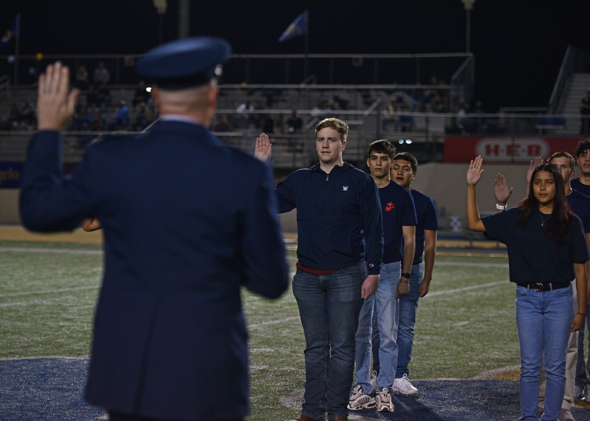 Members from the delayed entry program took the oath of enlistment during the Military Appreciation Night at 1st Community Credit Union Field, Nov. 6, 2021. U.S. Air Force Col. Matthew Reilman, 17th Training Wing commander, administered the U.S. Armed Forces Oath of Enlistment to multiple future members of the Armed Forces. (U.S. Air Force photo by Senior Airman Ashley Thrash)