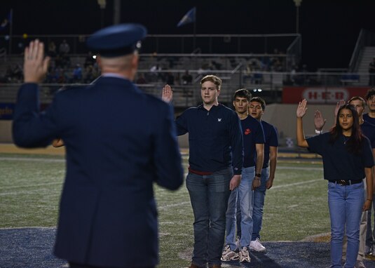 Members from the delayed entry program took the oath of enlistment during the Military Appreciation Night at 1st Community Credit Union Field, Nov. 6, 2021. U.S. Air Force Col. Matthew Reilman, 17th Training Wing commander, administered the U.S. Armed Forces Oath of Enlistment to multiple future members of the Armed Forces. (U.S. Air Force photo by Senior Airman Ashley Thrash)