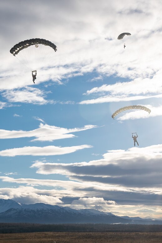 U.S. Air Force pararescuemen assigned to the 212th Rescue Squadron, Alaska Air National Guard, descend upon Malemute Drop Zone during a training event at Joint Base Elmendorf-Richardson.