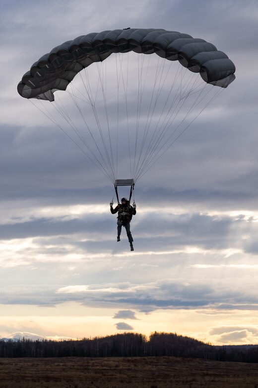 U.S. Air Force Senior Airman Nathan Graber, a pararescueman assigned to the 212th Rescue Squadron, Alaska Air National Guard, descends upon Malemute Drop Zone during a training event at Joint Base Elmendorf-Richardson.