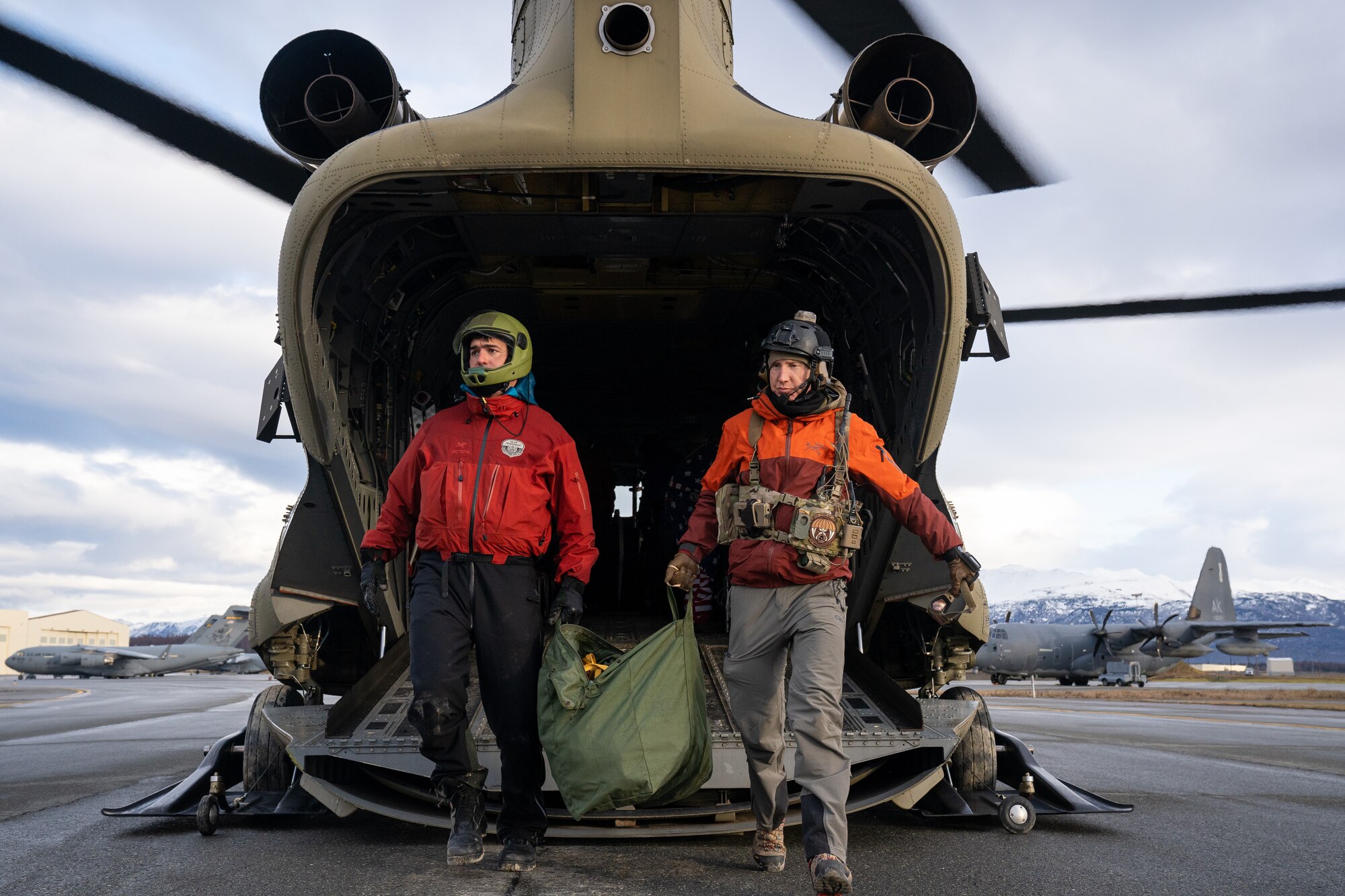 U.S. Air Force Capt. Dan Warren (left) and Maj. Miles Brodsky (right), both combat rescue officers assigned to the 212th Rescue Squadron, depart a CH-47J Chinook operated by Detachment 1, Bravo Company, 2-211th General Service Aviation Battalion, Army National Guard, after a training event at Joint Base Elmendorf-Richardson, Alaska.