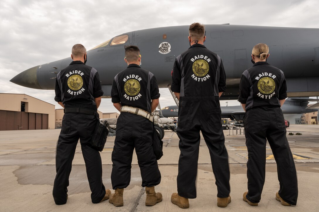 A weapons loading team stands on the flightline at Ellsworth Air Force Base, S.D., Sept. 13, 2021. Squadron leadership chose these airmen for the competition based on their weapons loading evaluation pass rate and overall knowledge of weapons loading procedures. (U.S. Air Force photo by Senior Airman Michael Ward)