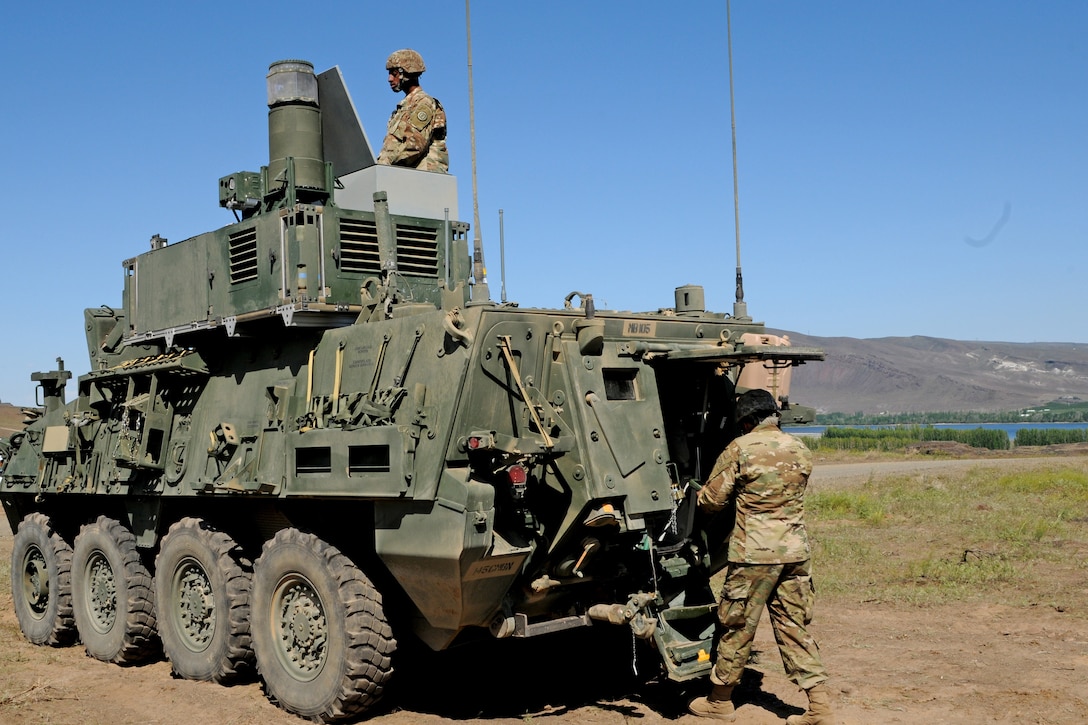 Soldiers work on a tactical vehicle.