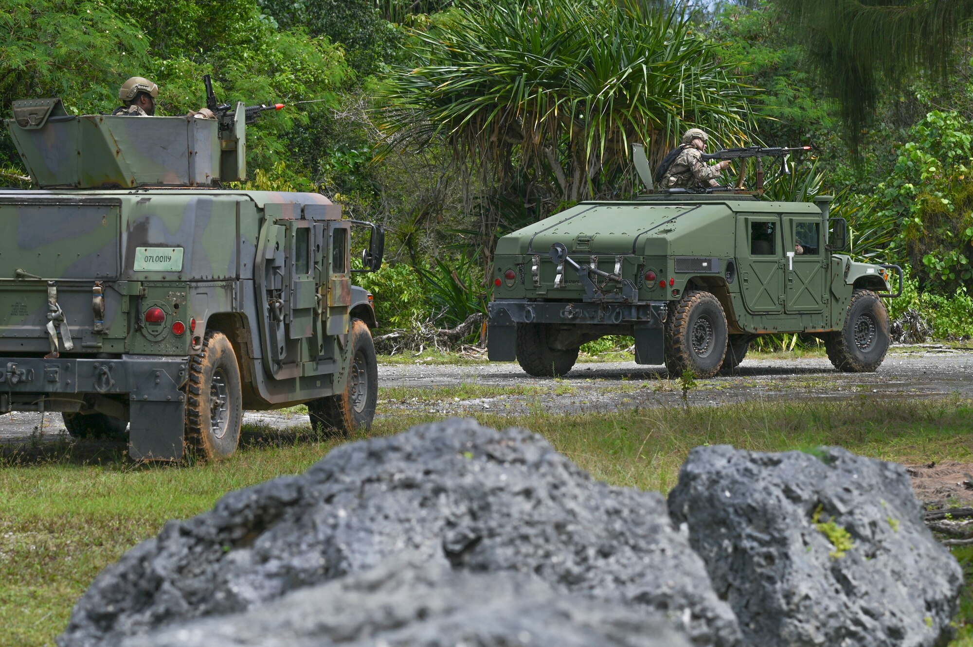 Two Humvee's with Airmen sticking out of the top.