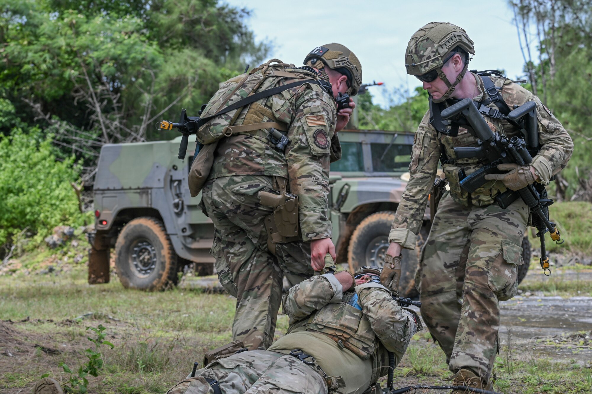 Two men dragging their wingman.