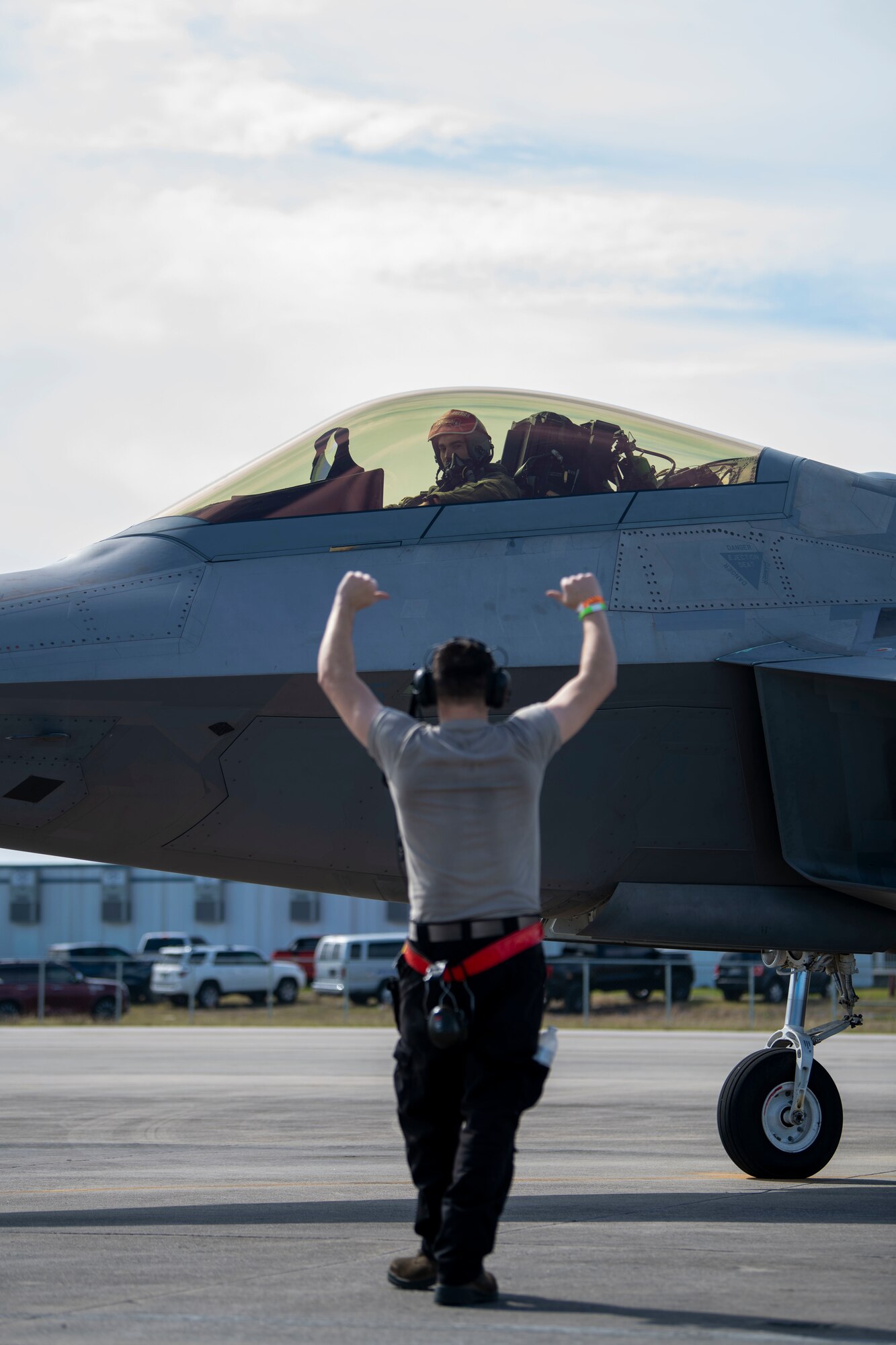 man in foreground, jet behind