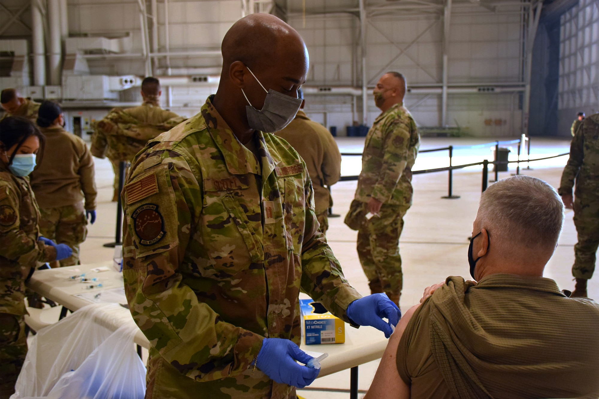 Capt. Albert Scott Jr., 433rd Medical Squadron critical care nurse, administers a vaccine to a Reserve Citizen Airman Nov. 6, 2021 at a mass vaccination event at Joint Base San Antonio-Lackland, Texas. These vaccination clinics are designed to help reduce illness and lost work time. (U.S. Air Force photo by Staff Sgt. Monet Villacorte)