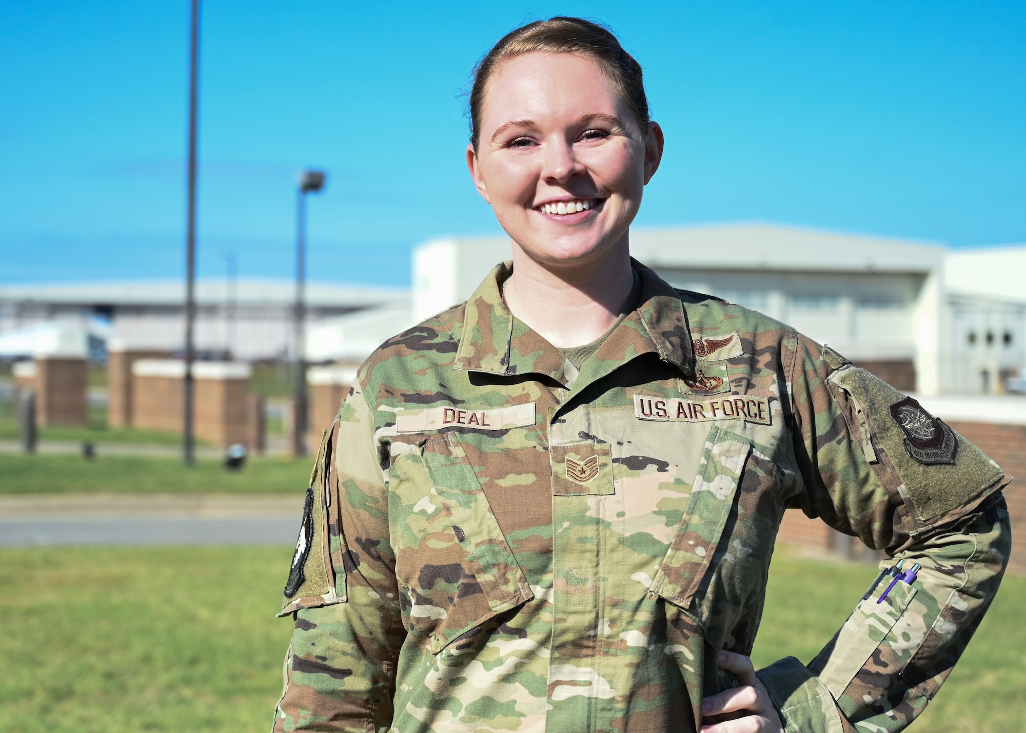 An Airman stands in fron of the flightline.