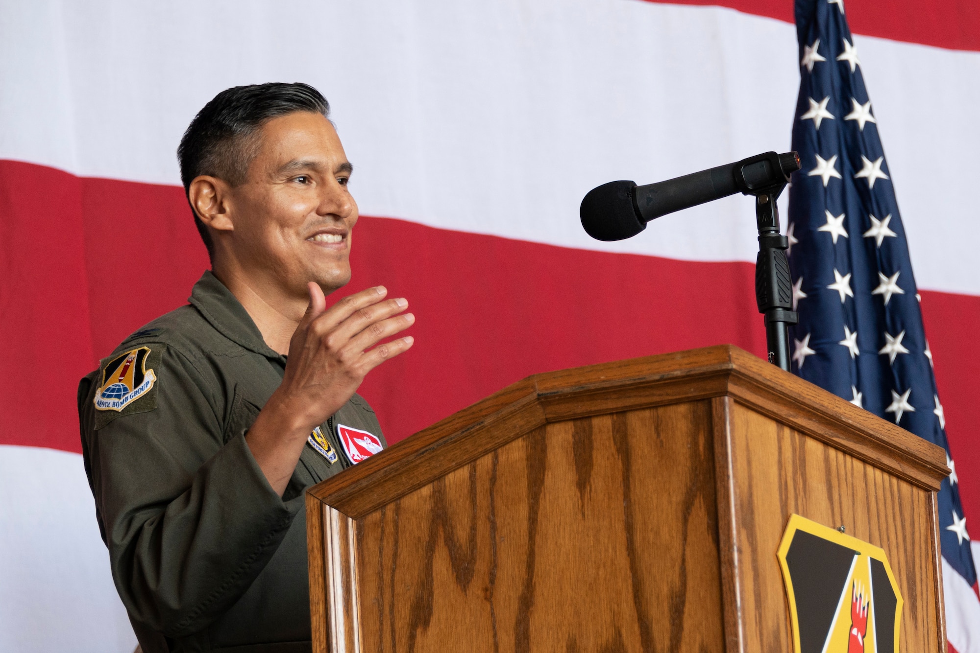 An airman speaks at a podium