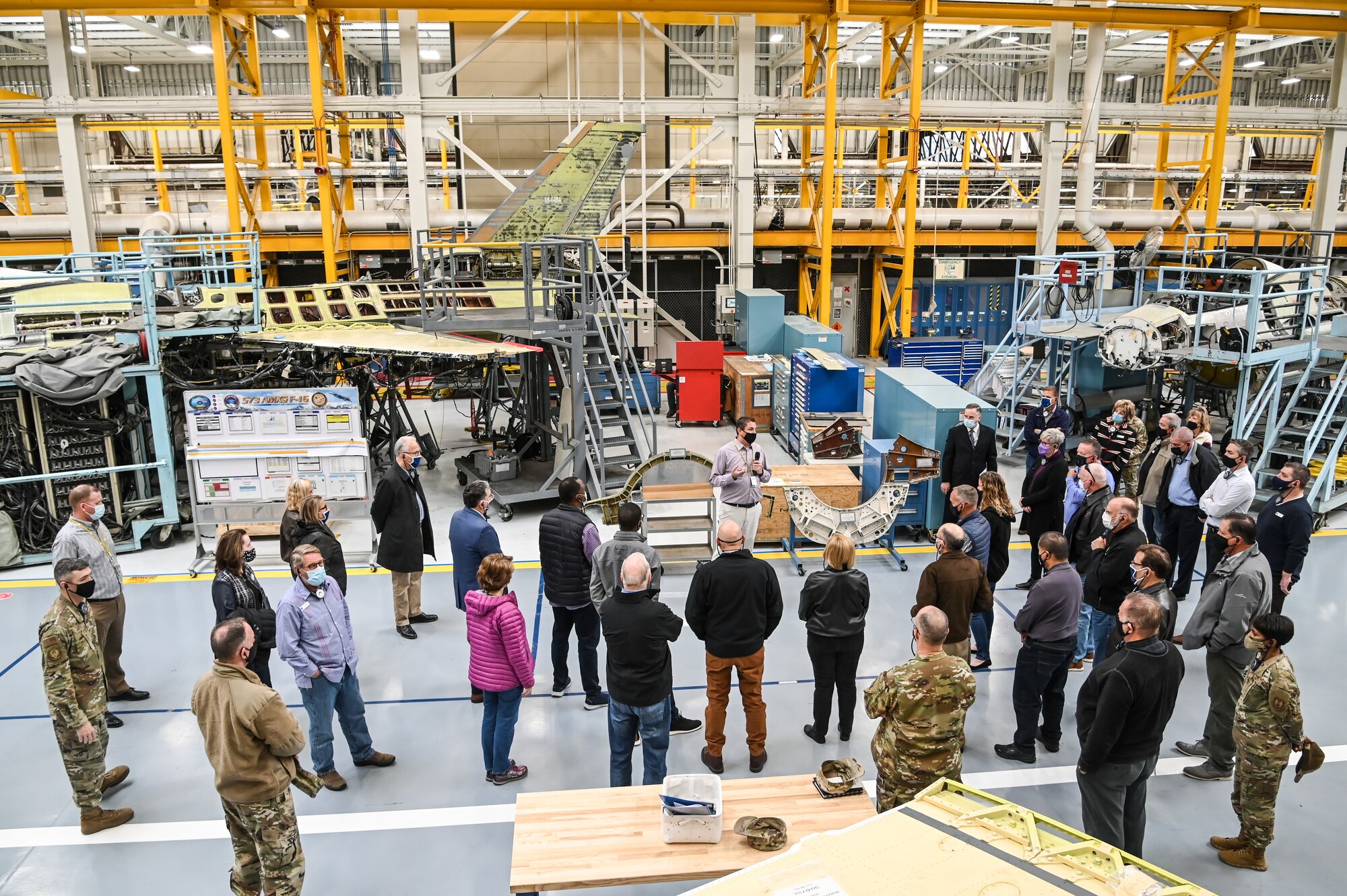 Community leaders with the Air and Space Force Civic Leader Program are briefed about Ogden Air Logistics Complex F-16 maintenance.