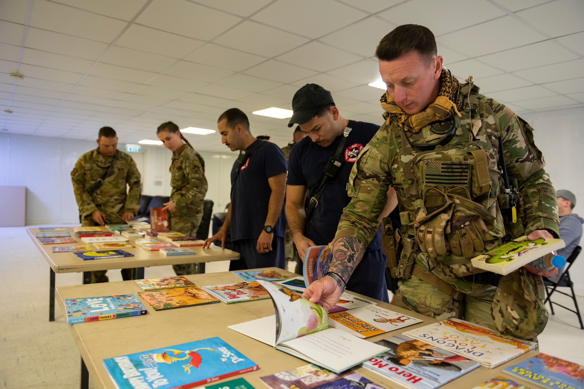 U.S. Airmen with the 332nd Air Expeditionary Wing pick out books to read for the Bob Hope Legacy Reading Program
