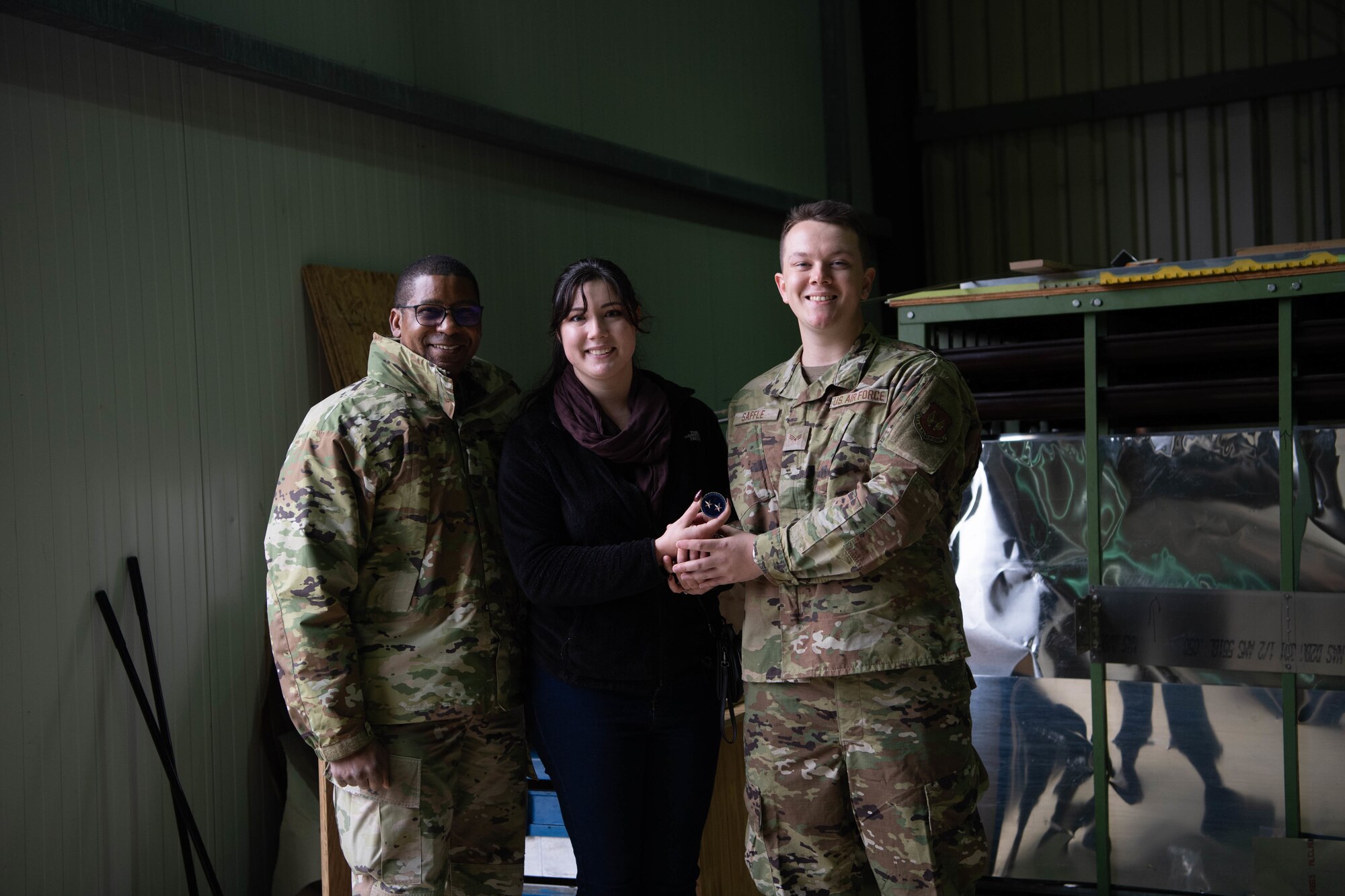 Airmen and a spouse pose for photo