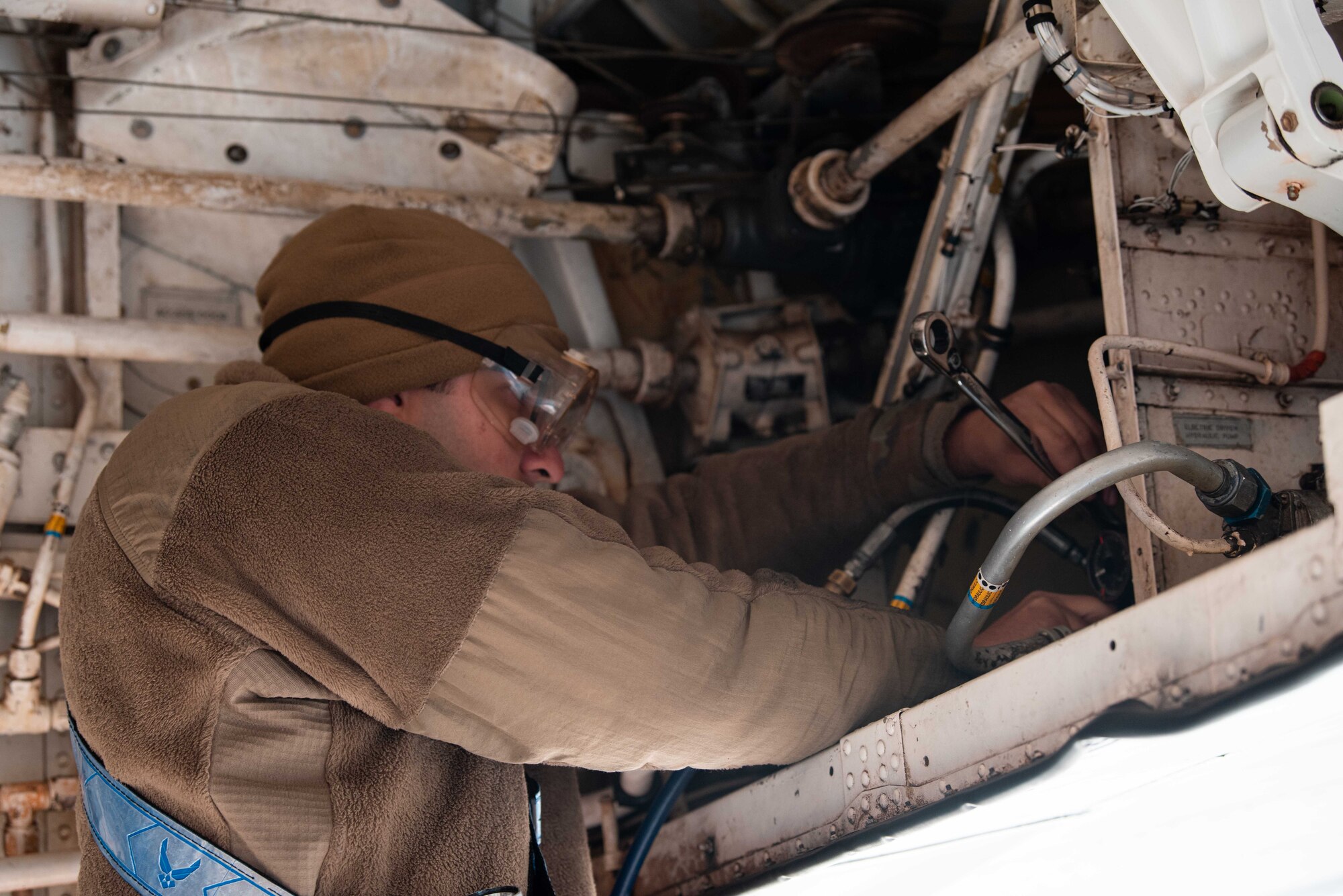 Airman Christopher Anderson, 22nd Aircraft Maintenance Squadron crew chief, services the preload accumulator on a KC-135 Stratotanker during Global thunder Nov. 5, 2021, at McConnell Air Force Base Kansas. The preload helps protect the hydraulic components during a pressure surge. Global Thunder is an annual command and control exercise designed to train U.S. Strategic Command forces and assess joint operation readiness. (U.S. Air Force Photo by Airman 1st Class Zachary Willis)