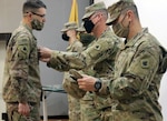 Sgt. Maj. Alex Young pins staff sergeant rank on Joseph Nowak